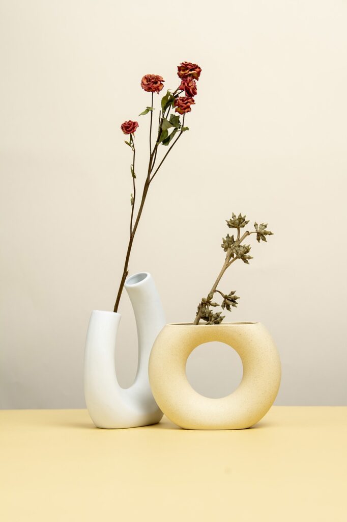 two flowers in artistic Vases